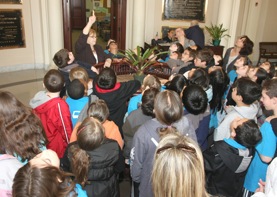 Students learning about the history of the Theodore Roosevelt Executive and Legislative Building 